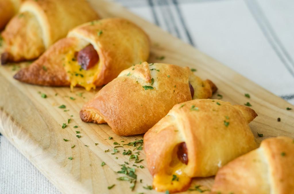 This image shows air fryer pigs in a blanket with cheese.