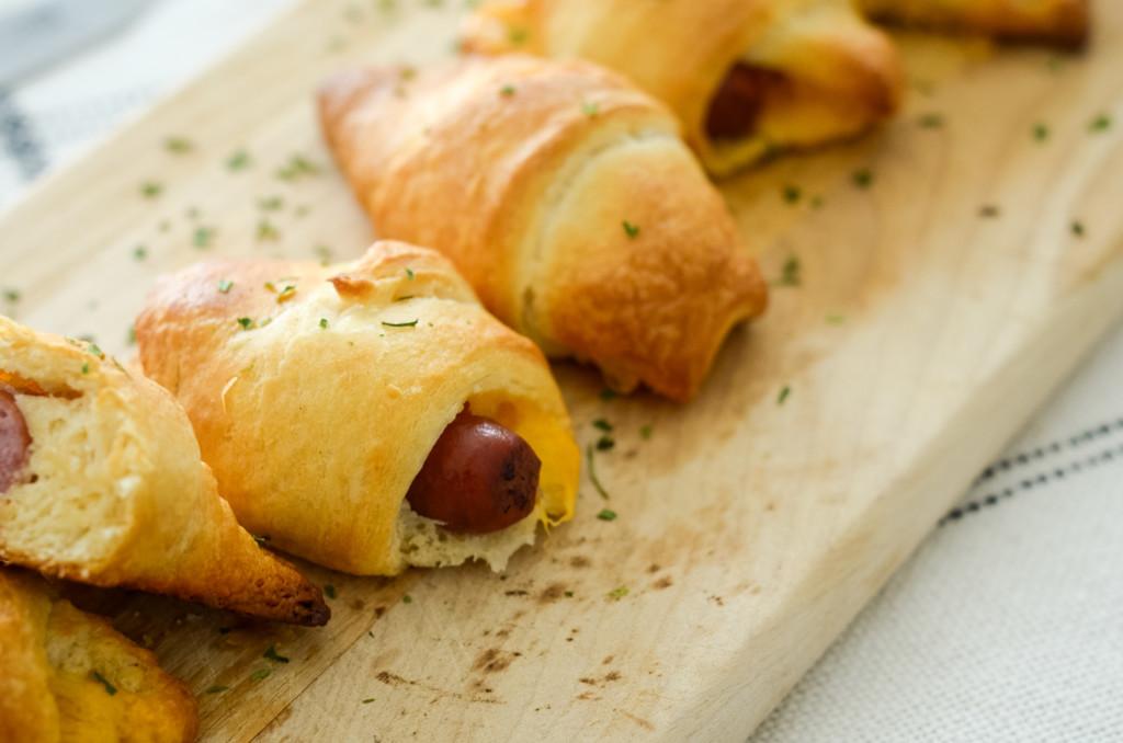 This image shows cocktail sausage inside a crescent roll.