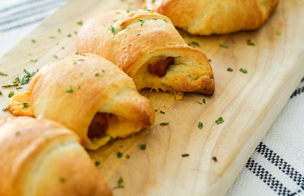 This image shows prepared pigs in a blanket with cheese made in the air fryer.