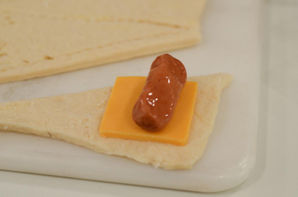 preparing pigs in a blanket with cheese