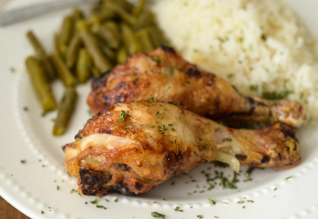 Air Fryer Teriyaki Chicken Legs plated with green beans and rice - gluten free.