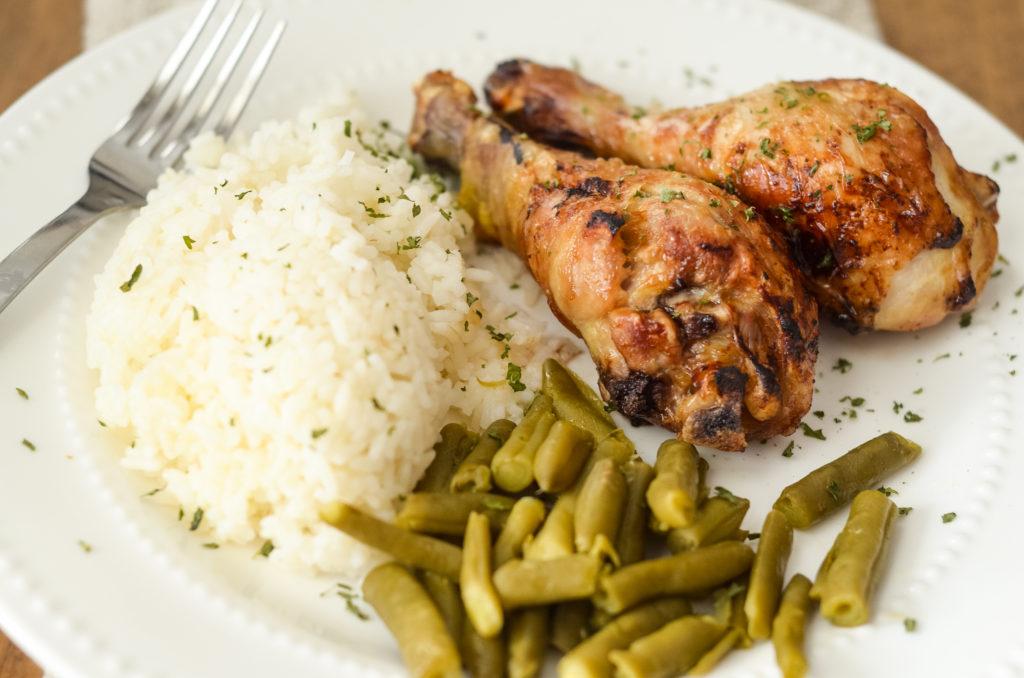 Air Fryer Teriyaki Chicken Legs plated with green beans and rice - gluten free.